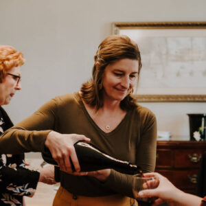 Cara pouring wine