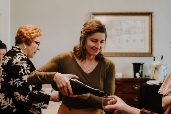 Cara pouring wine